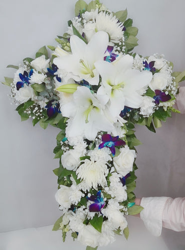 Cross-shaped tribute with a seasonal mix of flowers